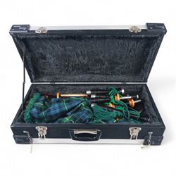 Set of late 20th century silver mounted bagpipes, the turned ebonised hardwood drone rods with Celtic knot and stipple engraved silver collars and ivorine mounts, hallmarked Bernie Leigh, Birmingham 1991, with R.G Hardie Glasgow plastic chanter and bag in green and blue Armstrong tartan, contained within a plush lined hard case, with a collection of spare reeds, drone rods, chanter, bags, cleaning accessories and other accessories 