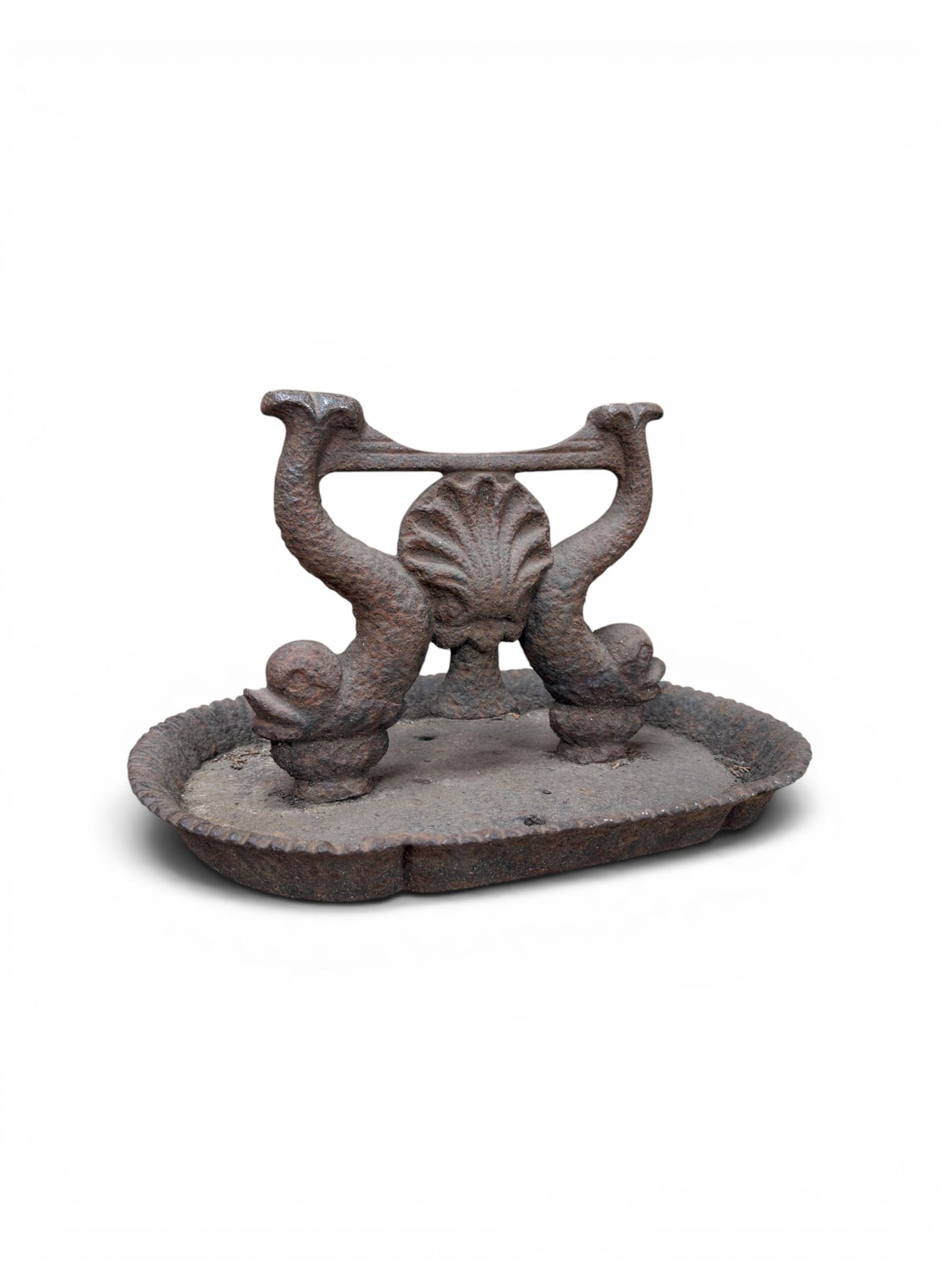 Victorian cast iron boot scraper, supported by two dolphins with central shell motif