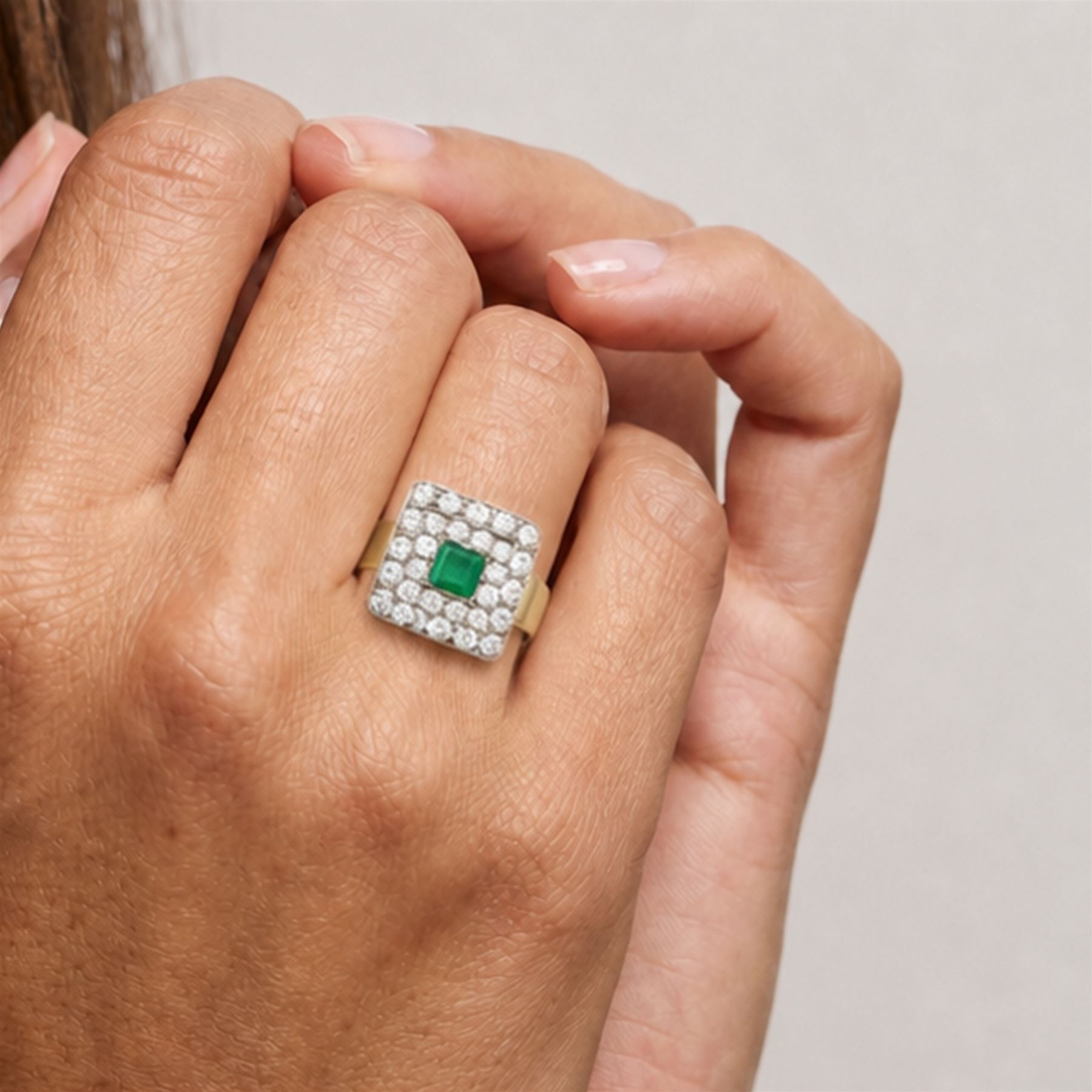 18ct gold emerald and diamond cluster ring, single octagonal cut emerald of approx 0.60 carat, surrounded by two rows of round cut diamonds in a square setting, total diamond weight approx 1.10 carat 