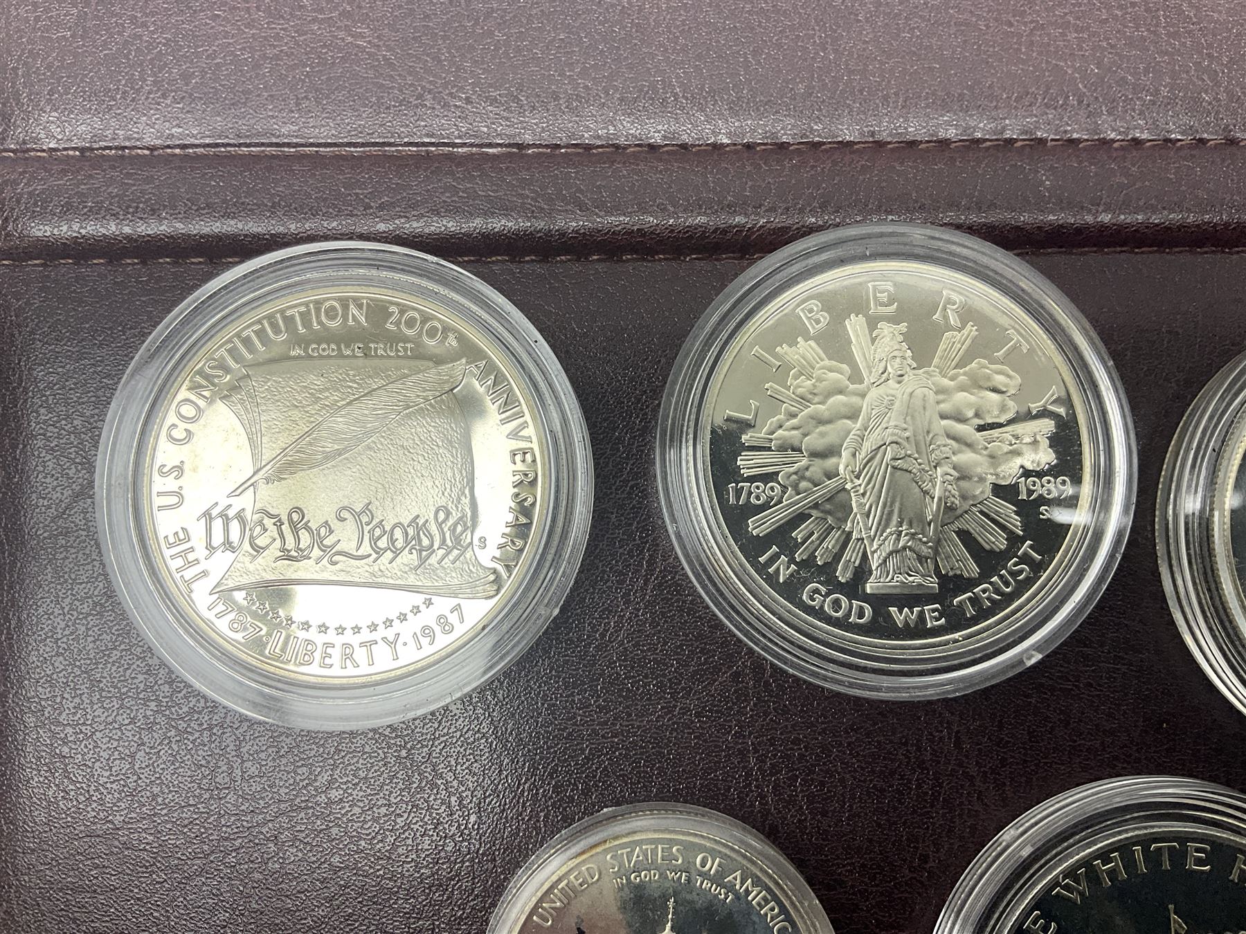 Five United States of America commemorative silver proof coins, comprising 1986, 1987, 1989, 1992 one dollars and 1982 half dollar, all with certificates