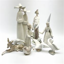 A group of nine Lladro figures, modelled in various forms including donkey, three geese, girl with chamber stick, etc. 