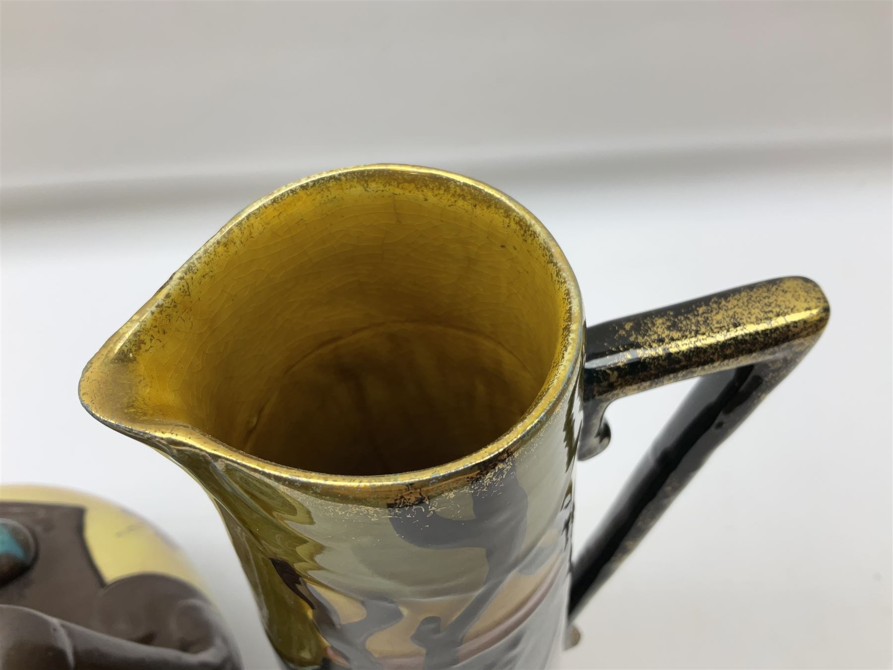 T. Forester Phoenix ware ewer of tapering form decorated with peacock and Bretby twin handled vase decorated with figures fishing in a boat sea scene