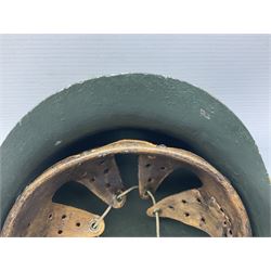 Fully restored German steel helmet, the camouflage painted exterior with two decals and replacement leather liner