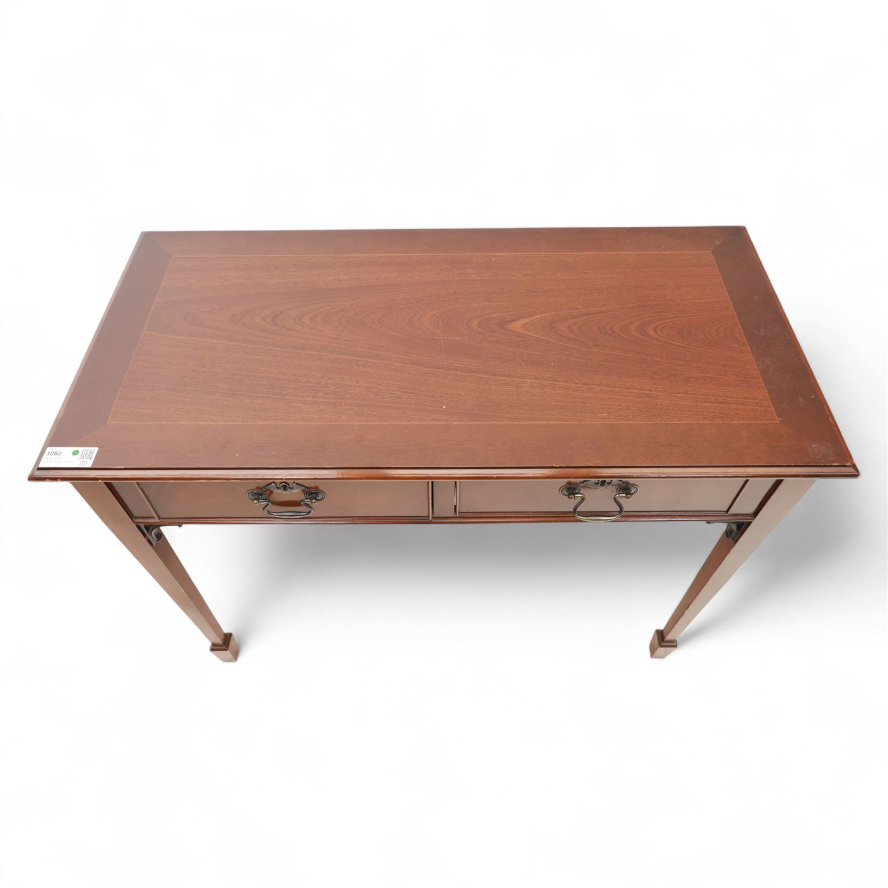 Edwardian design mahogany desk, crossbanded rectangular top above twin drawers with brass handles, raised on square tapering legs terminating in spade feet