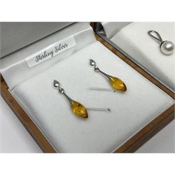 Silver jewellery comprising Baltic amber dolphin pendant necklace, Baltic amber Celtic design pendant necklace and five pairs of stone set pendant earrings, all boxed 