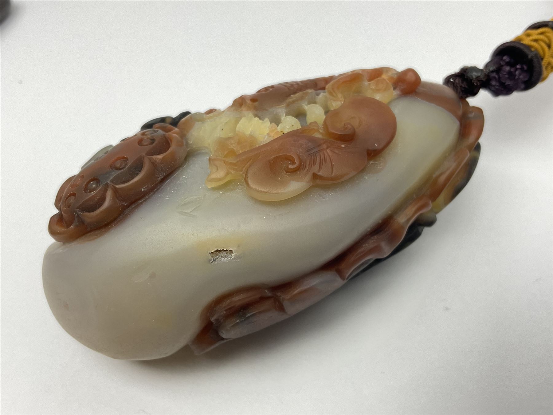 Chinese hardstone carving of a fish amongst coral, with platted rope handle, together with other hardstone and soft stone carvings  