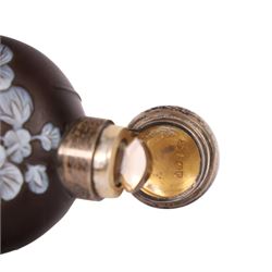 Victorian Thomas Webb silver mounted cameo glass scent bottle, hallmarked Sampson Mordan and Co, London 1884, the cameo glass body of circular form, decorated with white flowers and foliage in high relief upon a black ground, the hinged cover opening to reveal the original stopper, H6cm 