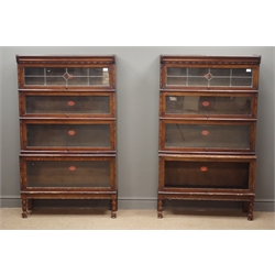  Pair mid 20th century oak 'Hillhead' sectional stacking library bookcases by Peter Graham Glasgow, two lead glazed and six glazed hinged doors, turned supports, W87cm, H147cm, D29cm  