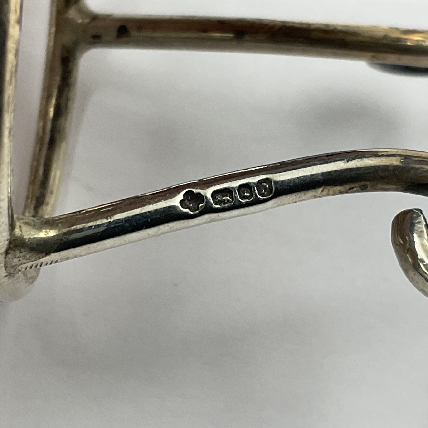 Modern silver limited edition Easter egg, no. 70/500, the gilt openwork body decorated with daffodils and detachable cover with pierced circular panel set with a single faceted blue stone, opening to reveal a gilt interior, upon silver stand with three scrolling pad feet, each hallmarked St James House Company, London 1980, height including stand 8cm