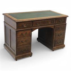 Victorian oak pedestal desk, the rectangular top with inset green leather writing panel an...
