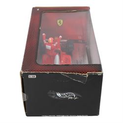 Signed Michael Schumacher Hot Wheels Ferrari 1:18 scale model, 2002 five-times World Champion edition depicting Schumacher sitting on the side of his car with arms raised, with his signature in black marker to wing of car, boxed