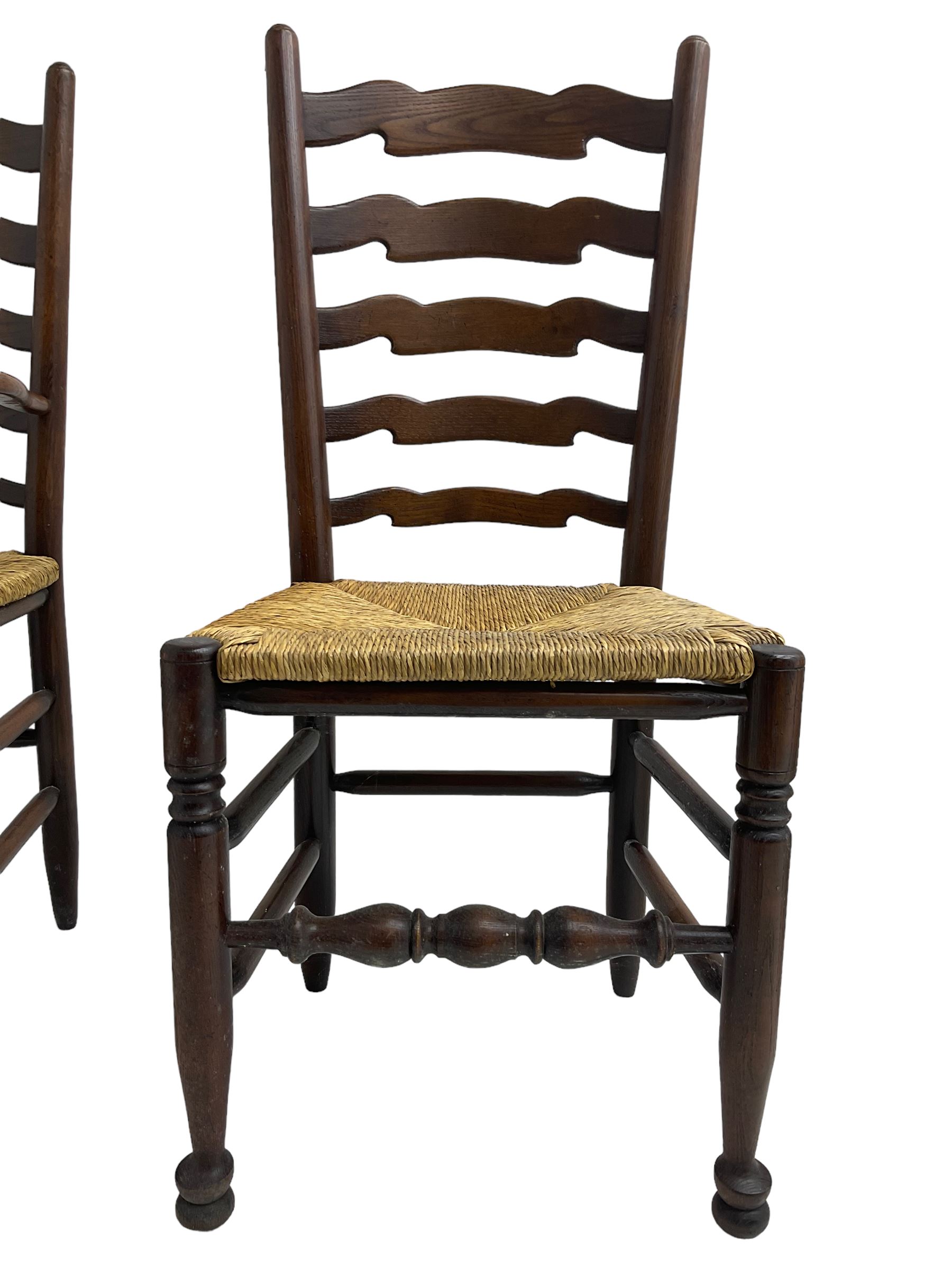 Set eight (6+2) oak dining chairs, high waived ladder back over rush seats, raised on ring turned supports with pad front feet, united by stretchers