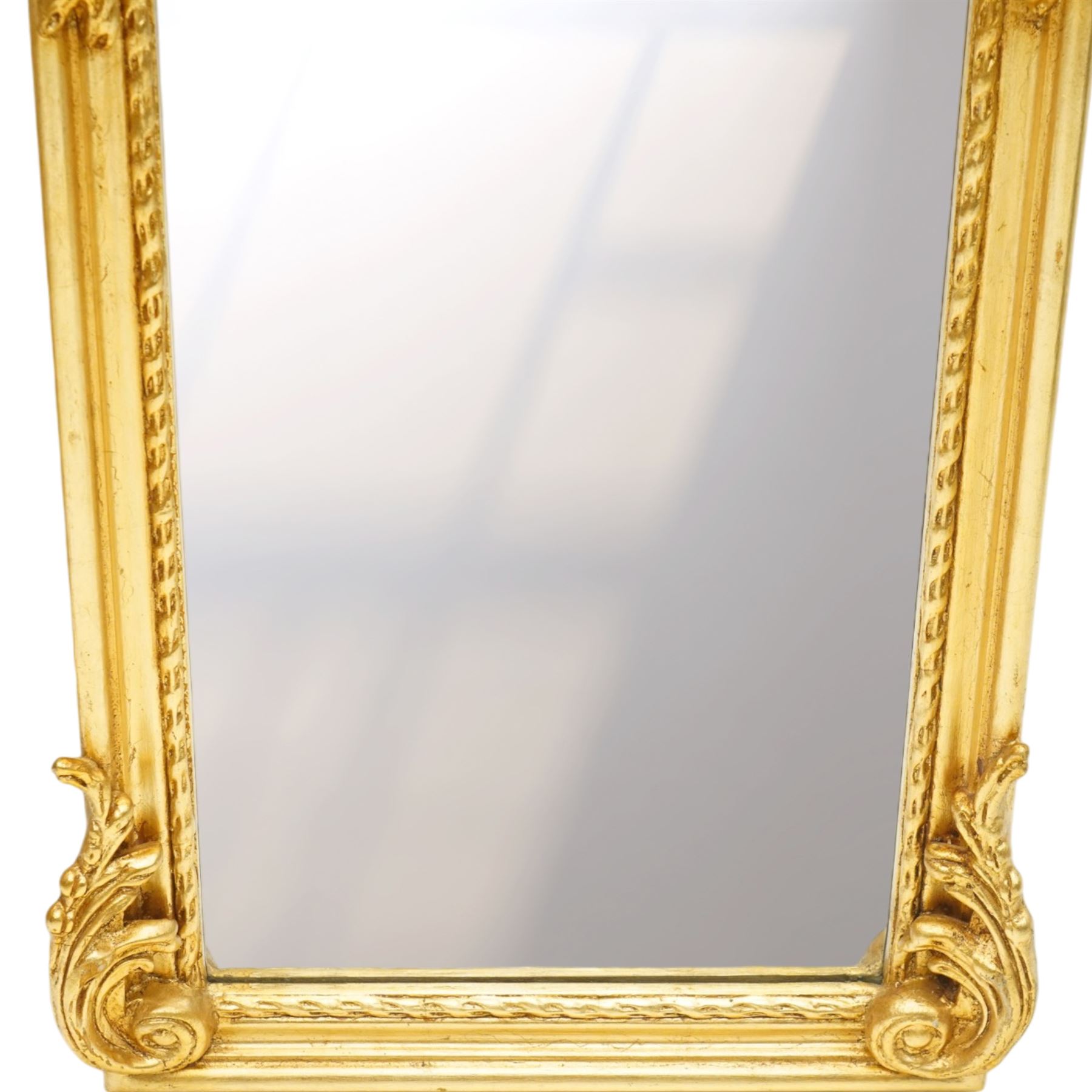 Pair of Rococo Revival gilt framed wall mirrors, the pierced scrolling rocaille pediment with foliate motifs over an oval panel with relief portraits of classically draped females, over a shaped rectangular bevelled plate surrounded by beading and scrolling foliate motifs