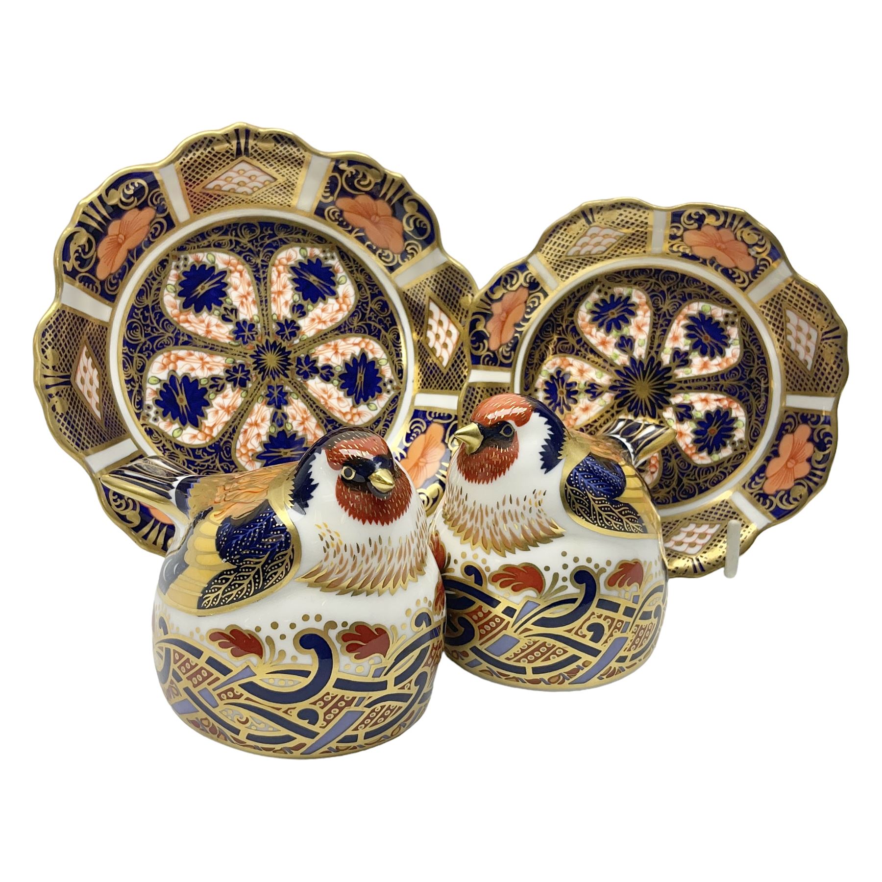 Two Royal Crown Derby Goldfinch Nesting paperweights with silver stoppers, together with two Royal Crown Derby imari pin dishes, largest dish D13cm