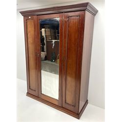 Victorian mahogany triple wardrobe, central mirrored door enclosing linen slides and two short and two long drawers flanked by two cupboards, plinth base