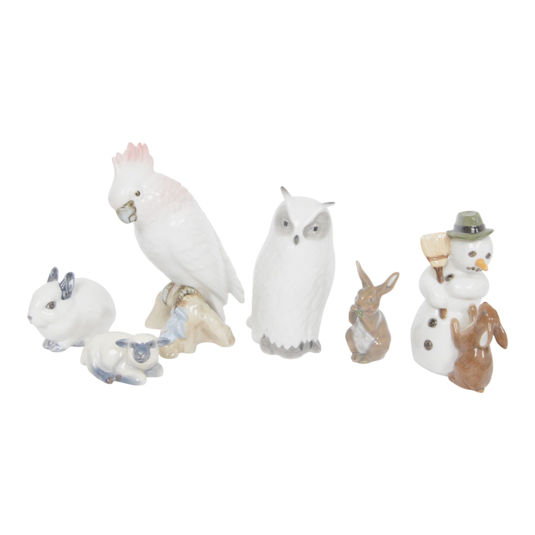 Royal Copenhagen, five figures including Owl 155, Snowman 017, Rabbit 154 etc, together with Royal Dux cockatoo
