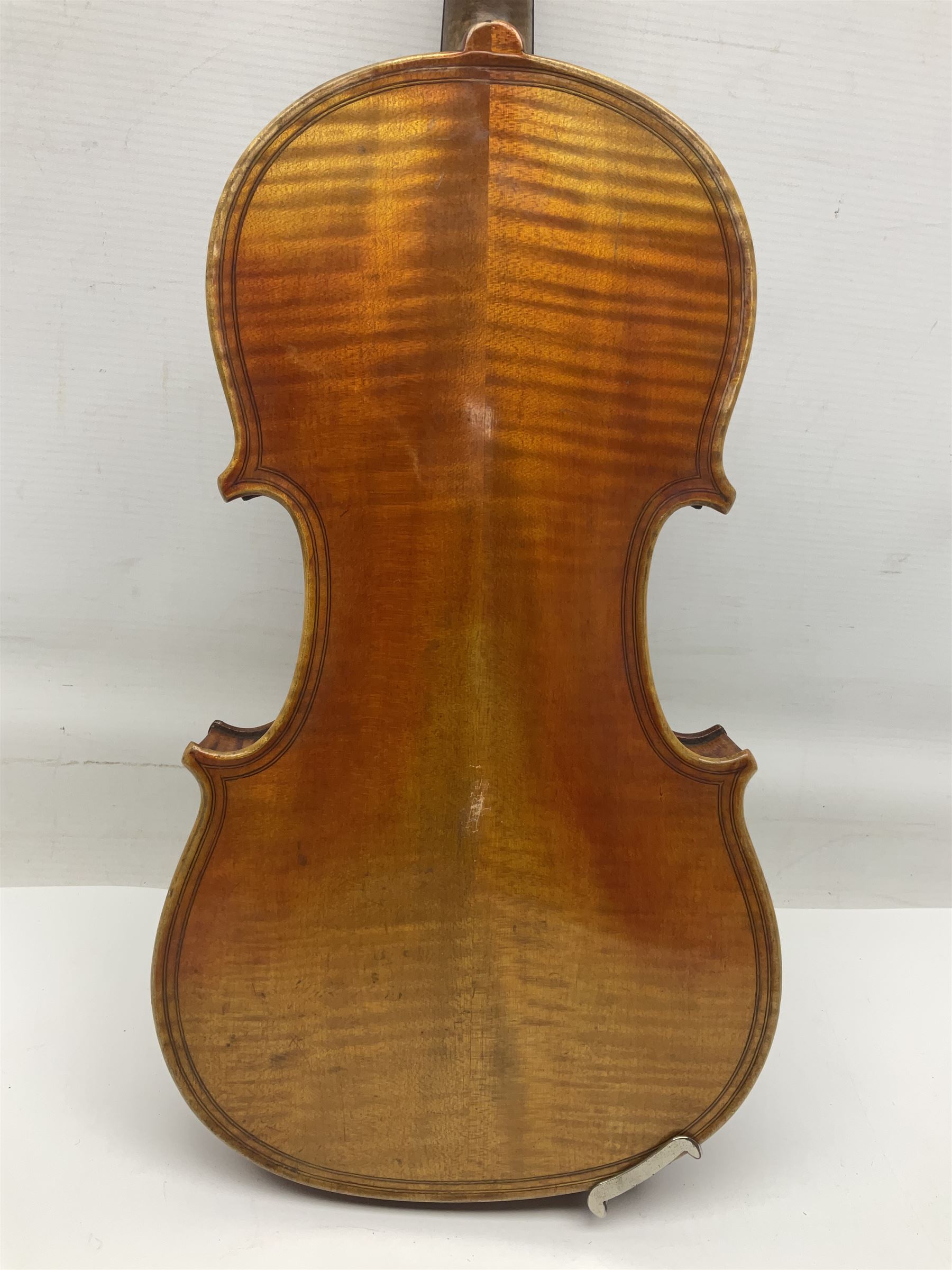 German trade violin c1900 copy of a Maggini with 36.5cm two-piece maple back and ribs and spruce top; double scroll; L60cm overall; in carrying case