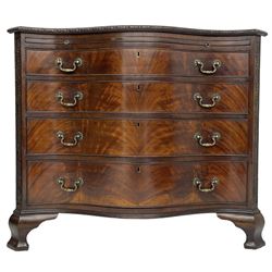 Chippendale design serpentine chest, shaped moulded top carved with repeating flower head motifs, fitted with brushing slide over four graduating drawers, pierced and foliate moulded handle plates with scrolled swan neck handles, canted upright corners carved with flower heads and strapwork, on canted ogee bracket feet