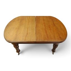Large Victorian oak extending dining table, the rectangular top with rounded corners and moulded edge, plain frieze over large turned lobed and fluted supports terminating to brass cups and castors, with two additional leaves
