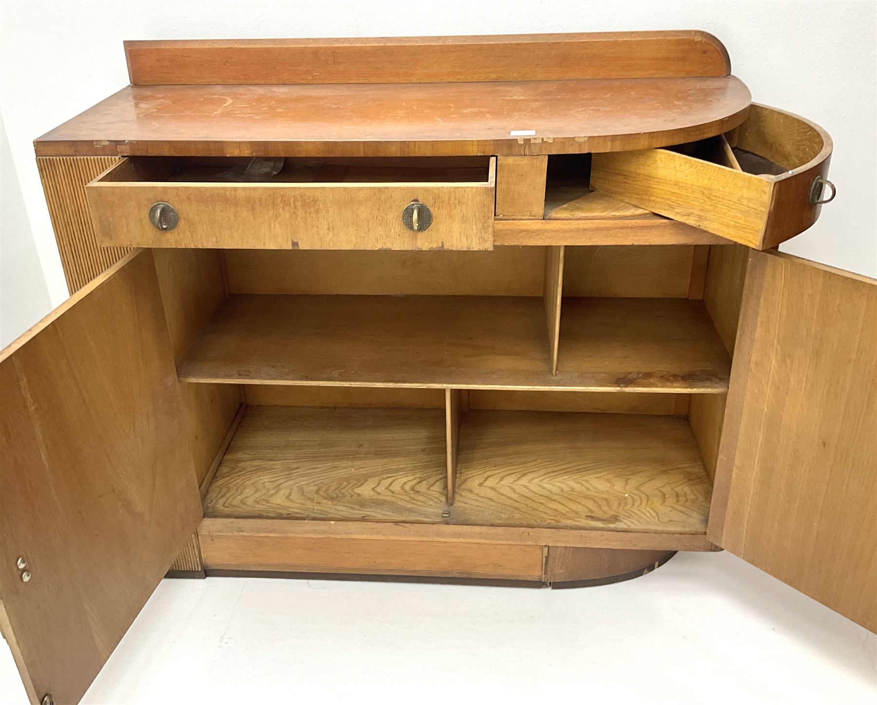 Art Deco oak sideboard, raised shaped back, two drawers above two cupboards, platform base