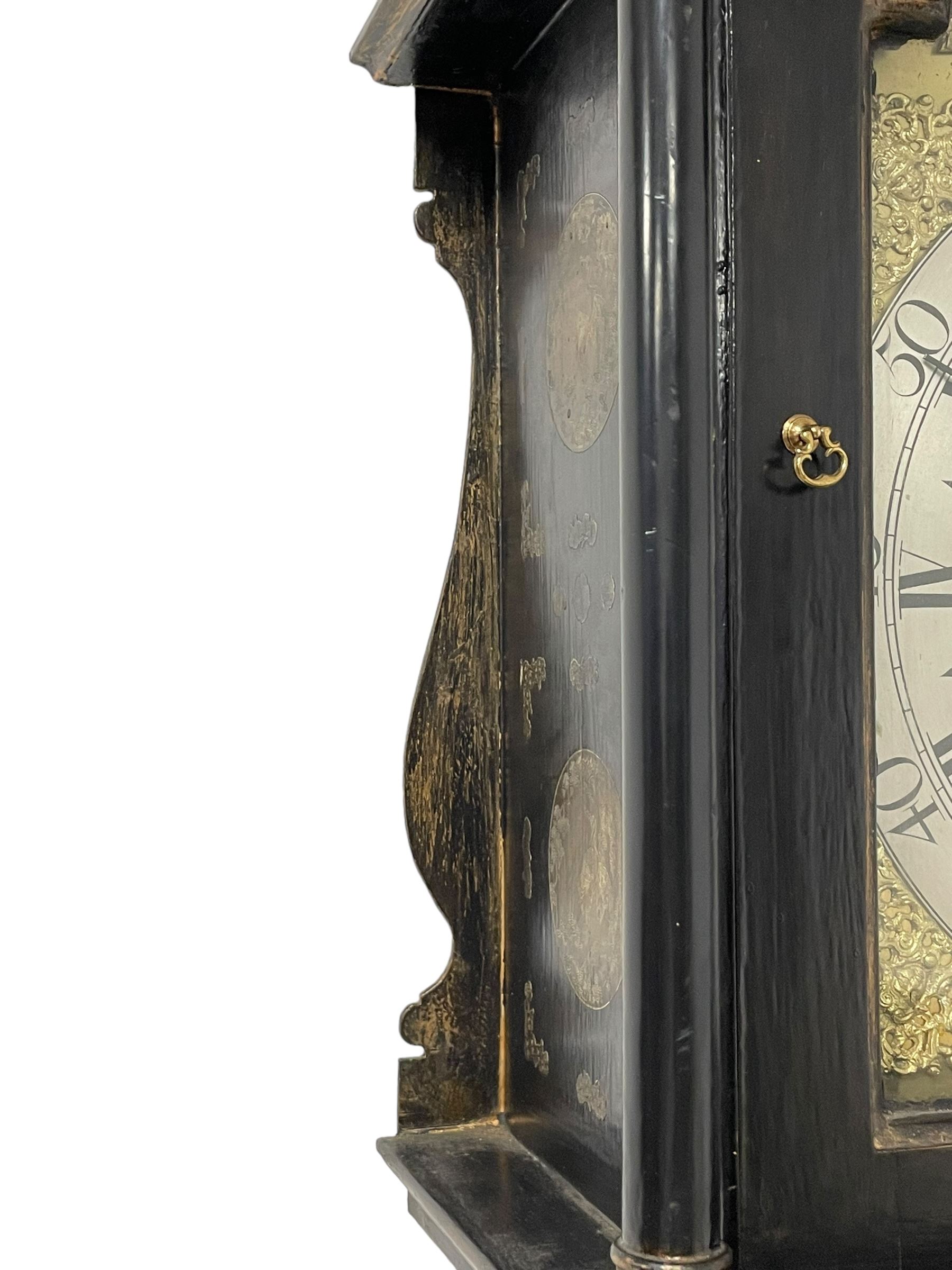 James Bowra of Sevenoaks Kent - 18th century 8-day ebonised longcase clock with gilt decoration c1740, with a flat top, dentil moulding beneath and shaped back splats, break arch hood door flanked by plain pilasters with wooden capitals, long trunk with a curved topped door, on a square plinth with canted corners and raised on a moulded base, brass dial with cast spandrels and a silvered 'Punch' automata to the arch, matted dial centre with seconds ring and date aperture, silvered chapter ring with Roman numerals, five minute Arabics, minute and quarter hour tracks, with matching steel hands and silvered makers name plate, rack striking movement with a recoil anchor escapement, striking the hours on a bell. With weights and pendulum.