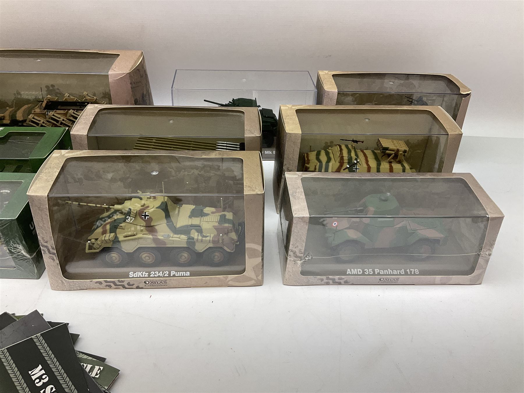 Sixteen Atlas Editions die-cast models of military vehicles including six Ultimate Tank Collection; all in perspex display cases; fourteen boxed; with associated paperwork (16)