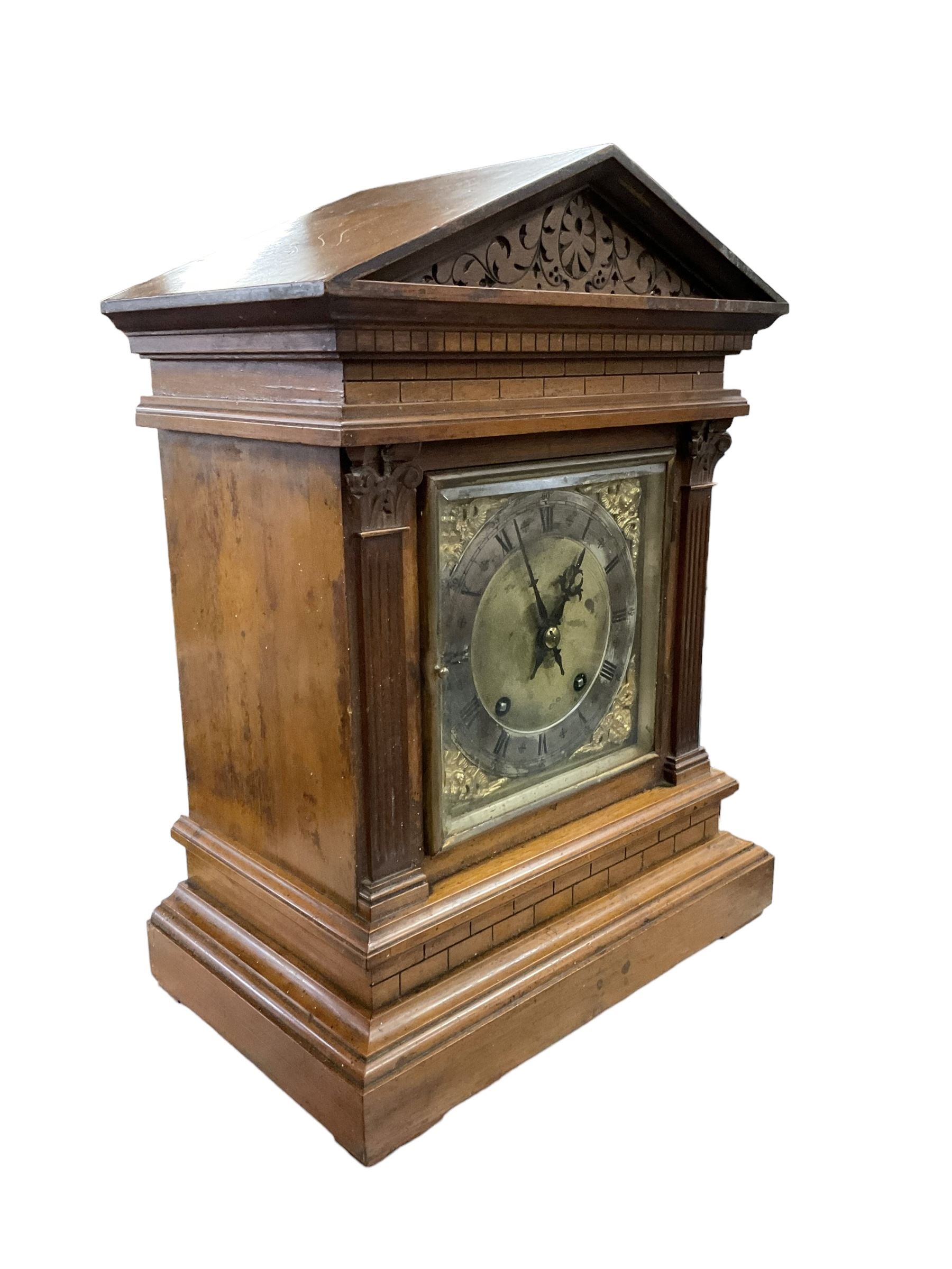 Winterhalder & Hofmeier - late 19th century Mahogany 8-day twin train mantle clock , with an architectural pediment  and carved tympanum, carved reeded pilaster to the front on a stepped plinth with  brickwork relief, square brass dial with cherub spandrels, matted dial centre and silvered chapter ring, dial pinned to a 