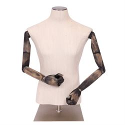 Male mannequin torso with fabric body and poseable wooden arms, on a square metal base