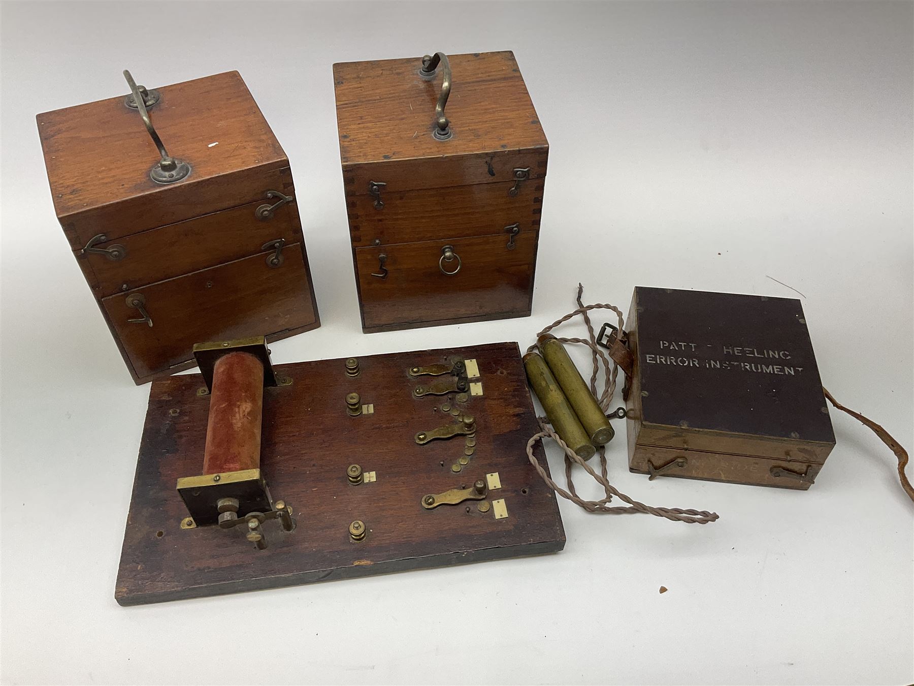 Heeling Error Instrument Patt.5 No.1613E (box numbered 1810E) with integrated spirit level D11cm; two walnut cased electric shock machines; and a similar board mounted electric shock machine (4)