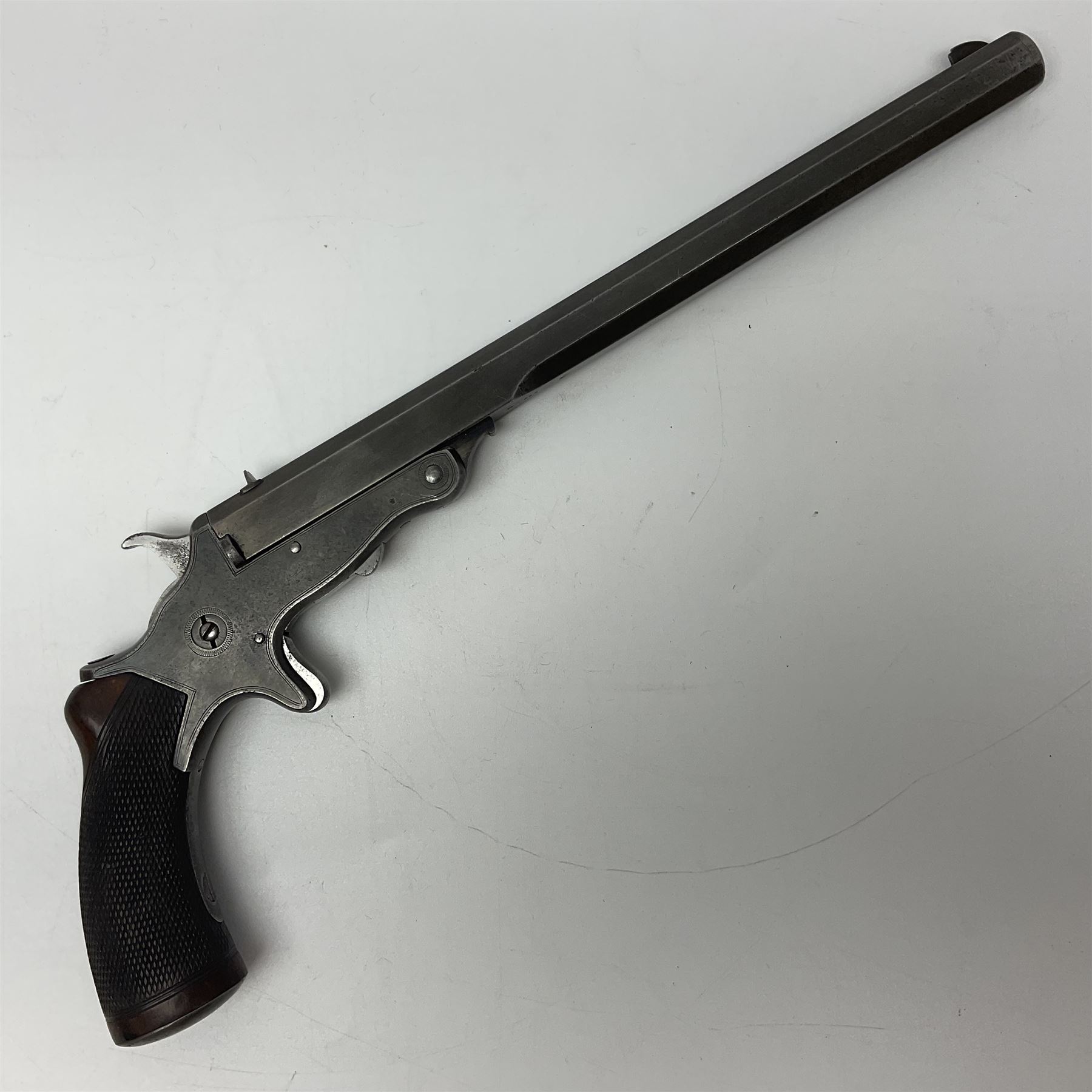 19th century .297/230 rimfire single shot break-action pistol, ''Tranter's Patent'', no.2;  the 25cm octagonal barrel marked Kynoch Gun Factory Aston; fin fore-sight, dove-tail standing notch rear-sight, open iron frame with barrel release button to the integral fore-end, central hammer, spur trigger and chequered walnut one-piece grip with domed iron pommel-cap L36cm overall