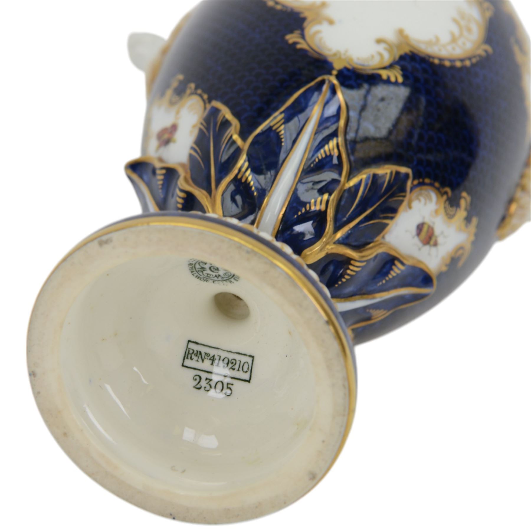 Late 19th century Royal Worcester porcelain vase and cover, circa 1897, of baluster form with twin lion masks to shoulders, painted with a reserve of exotic birds within a landscape, against a blue scale ground with gilt highlights, and further detailed with smaller reserves containing butterflies, the shoulder, base of body and foot with moulded acanthus bands, upon a circular spreading foot, with green printed marks beneath including shape number 2305 and Rd no 419210, H27.5cm