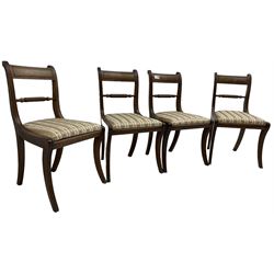 Set of four Regency period mahogany dining chairs, rope-twist centre back bar over pink and ivory floral patterned drop-in seats, on reed moulded sabre supports