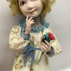 Anna Meszaros Hungary - three hand made needlewrok figurines - each wearing a lon floral dress and bonnet and holding a bouquet of flowers, tallest H32cm (3)  Auctioneer's Note: Anna Meszaros came to England from her native Hungary in 1959 to marry an English businessman she met while demonstrating her art at the 1958 Brussels Exhibition. Shortly before she left for England she was awarded the title of Folk Artist Master by the Hungarian Government. Anna was a gifted painter of mainly portraits and sculptress before starting to make her figurines which are completely hand made and unique, each with a character and expression of its own. The hands, feet and face are sculptured by layering the material and pulling the features into place with needle and thread. She died in Hull in 1998.