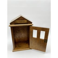 Edwardian oak domestic post box modelled as a sentry box, the pitched roof with brass inset panel to the front gable inscribed Letters, hinged door below with twin glass panes above panels, H39cm x W23cm 
