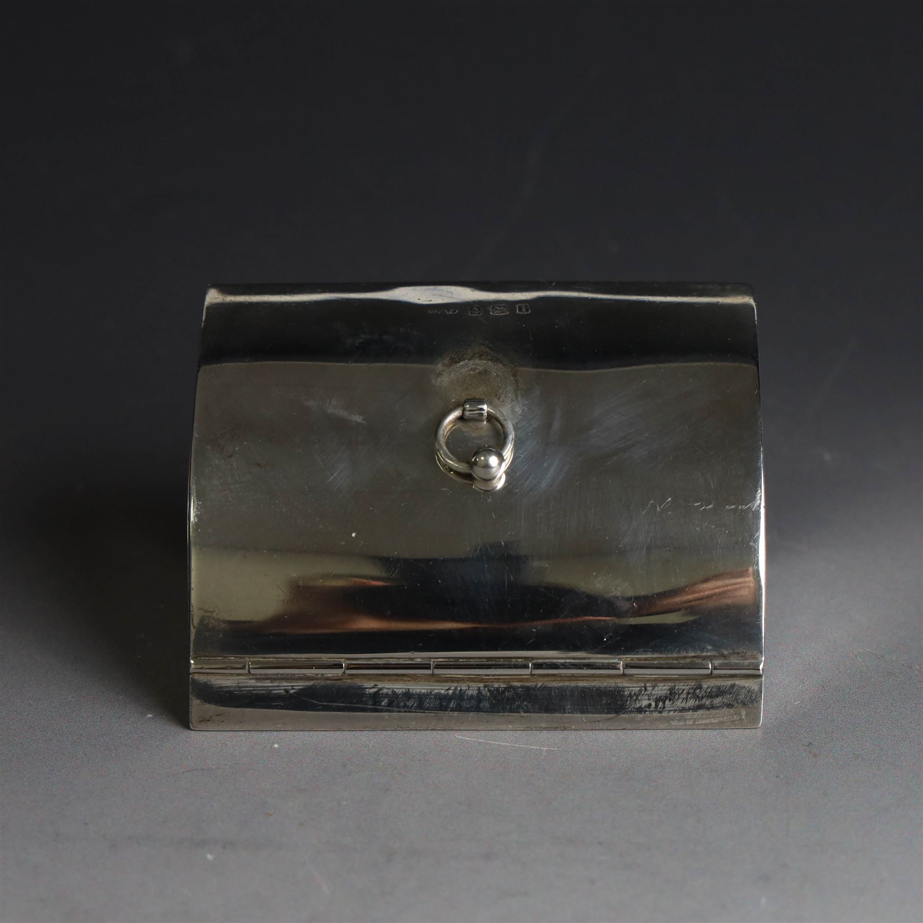 Edwardian silver fall-front ring box with loop handle, opening to reveal velvet interior with five ring spaces, hallmarked Deakin & Francis, Birmingham 1907, together with a cut glass jar with silver lid inscribed 'Hair Tidy' and a silver mounted capstan inkwell, both hallmarked 