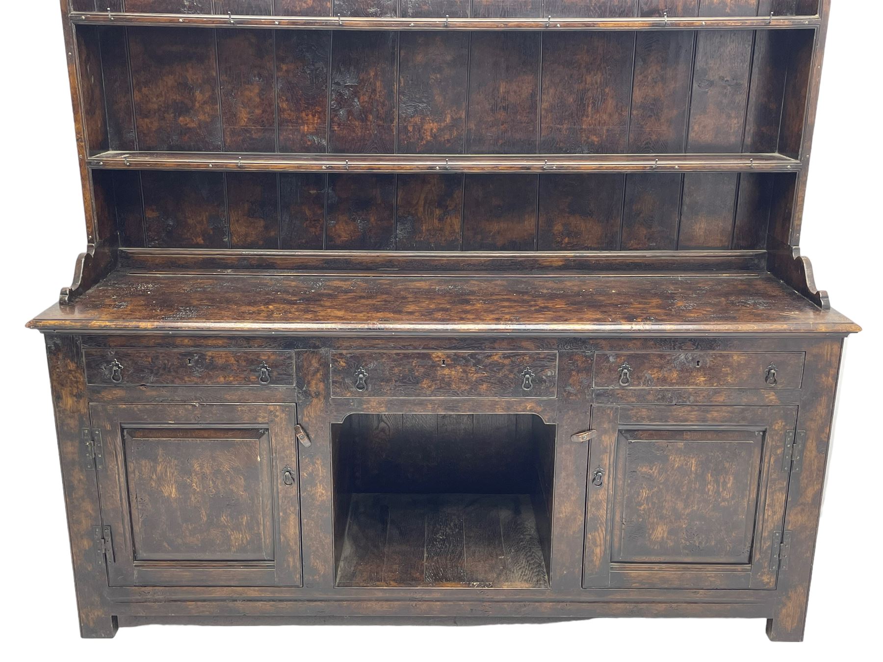 Bylaws of Leominster - 18th century design figured oak dog kennel dresser, the raised plate rack with projecting cornice over hooks and three tiers, moulded rectangular top over three drawers and two panelled cupboards, moulded frame and panelled sides, on stile supports