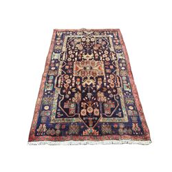 Persian Hamadan blue ground rug, decorated with stylised flower heads 