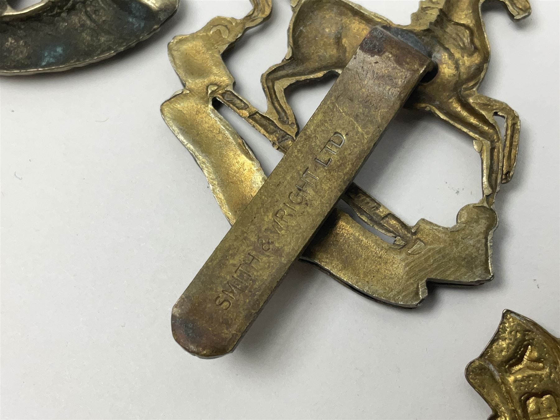 Twenty cap badges including Hertfordshire, Royal Sussex, Cambridgeshire, Hampshire, Notts and Derby, East Surrey, Herefordshire, South Lancashire, Devonshire, Bedfordshire, Durham Light Infantry etc (20)