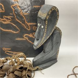 Collection of traditional necklaces from the Solomon Islands, including shell and boar tusk examples, together with a carved canoe prow, with mother of pearl eyes, painted cow hide and a copper plaque, depicting the Solomon Islands, with presentation engraving