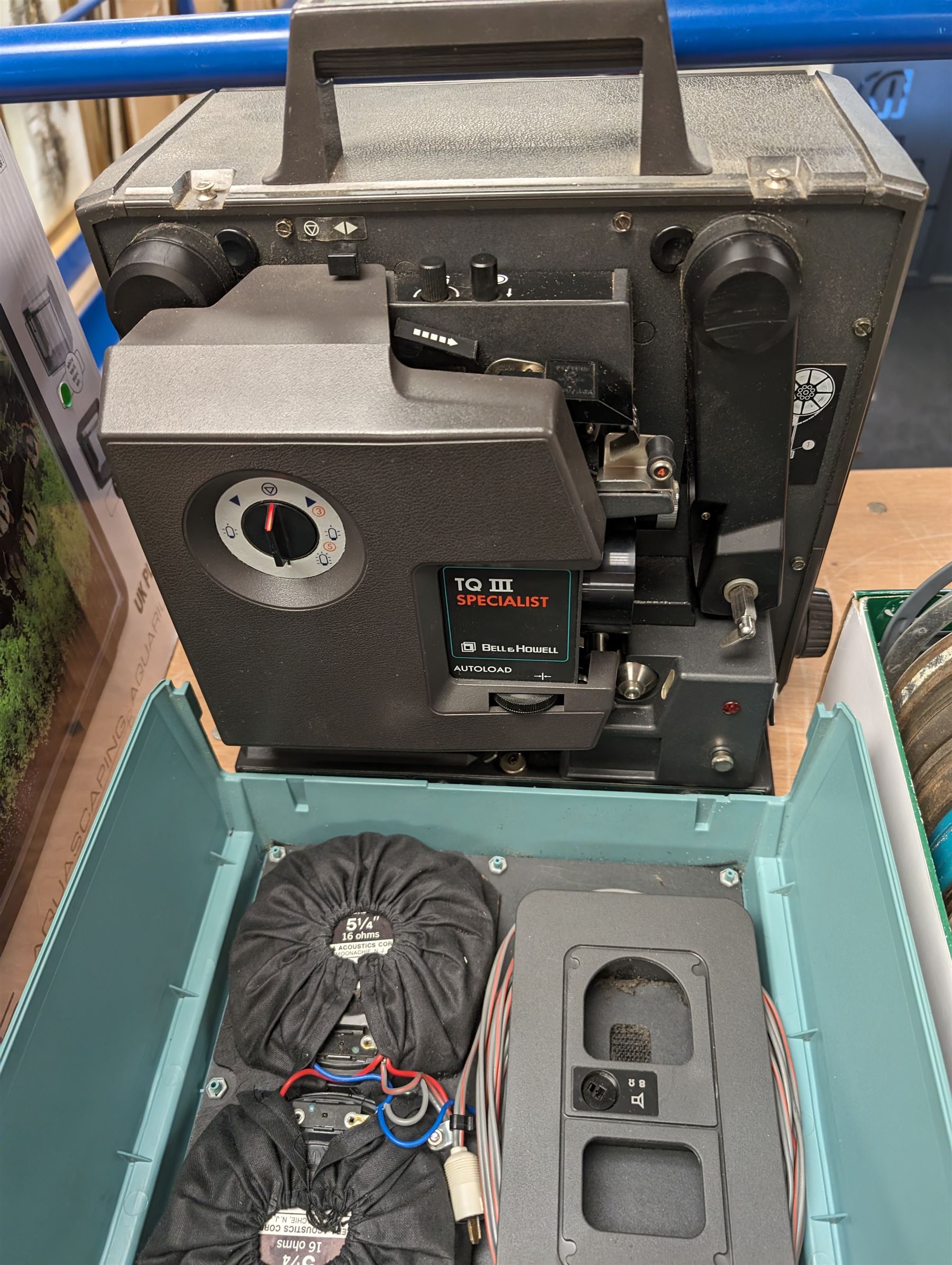Bell & Howell TQ III 16mm film projector, together with lenses and spare projector lamps and a quantity of 16mm film reels, including Kellogg advert, Tex Avery cartoon and other film reels