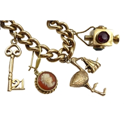 9ct gold curb bracelet with heart locket hallmarked,  with ten 9ct gold charms including stork carrying a baby, house, first aid box and an 18ct gold cross charm, all tested, hallmarked or stamped