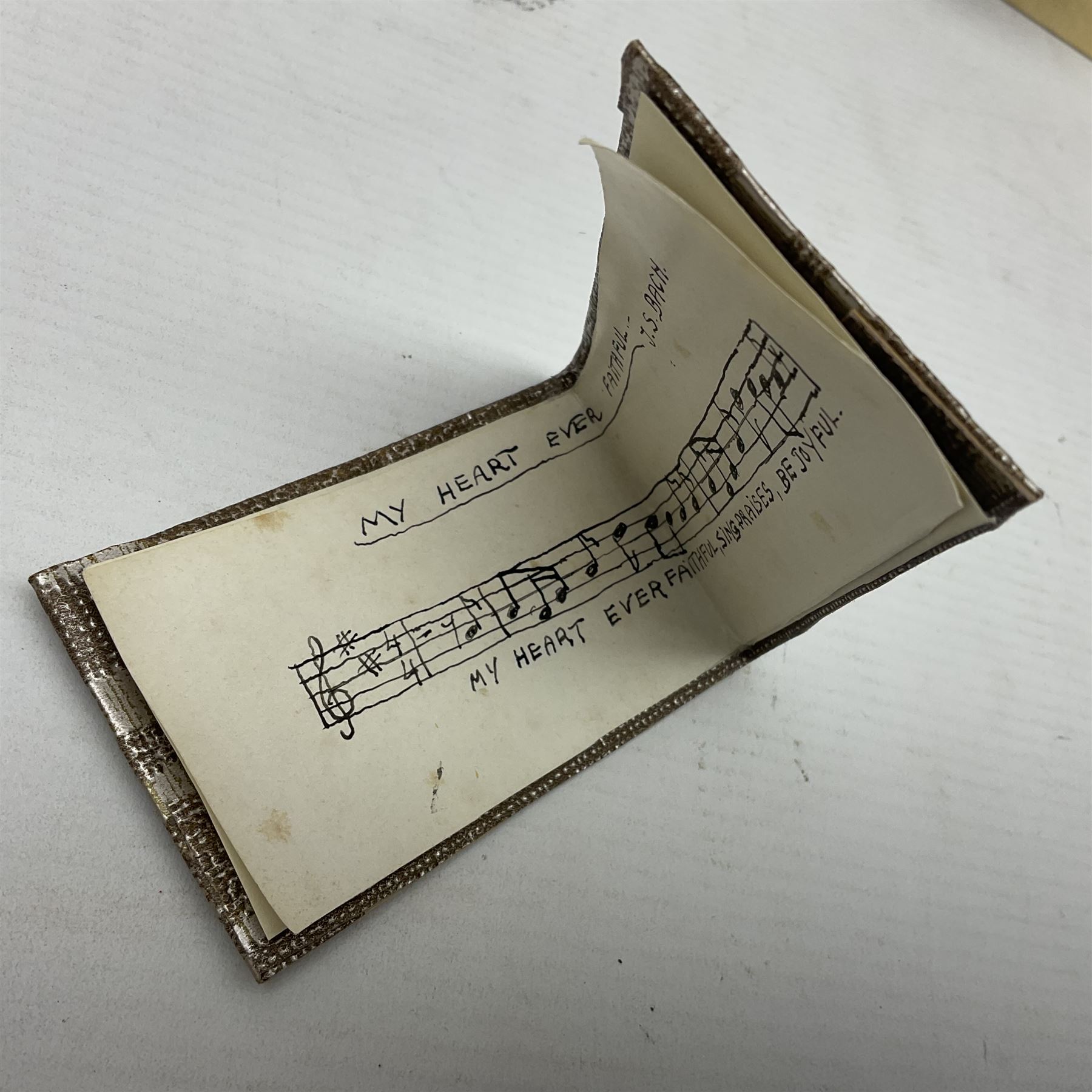 Anna Meszaros Hungary - three hand made needlework figurines - 'The Cobbler' as a child seated in a wooden rocking chair working on a removed boot H28cm; young girl in a long floral dress standing playing a harp H35cm; and young girl wearing a blue tabard standing playing a lute (3) Auctioneer's Note: Anna Meszaros came to England from her native Hungary in 1959 to marry an English businessman she met while demonstrating her art at the 1958 Brussels Exhibition. Shortly before she left for England she was awarded the title of Folk Artist Master by the Hungarian Government. Anna was a gifted painter of mainly portraits and sculptress before starting to make her figurines which are completely hand made and unique, each with a character and expression of its own. The hands, feet and face are sculptured by layering the material and pulling the features into place with needle and thread. She died in Hull in 1998.  