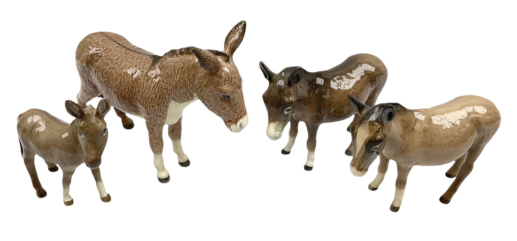 Beswick donkey family to include no.1364b, no.2267a, another donkey and donkey foal (4)