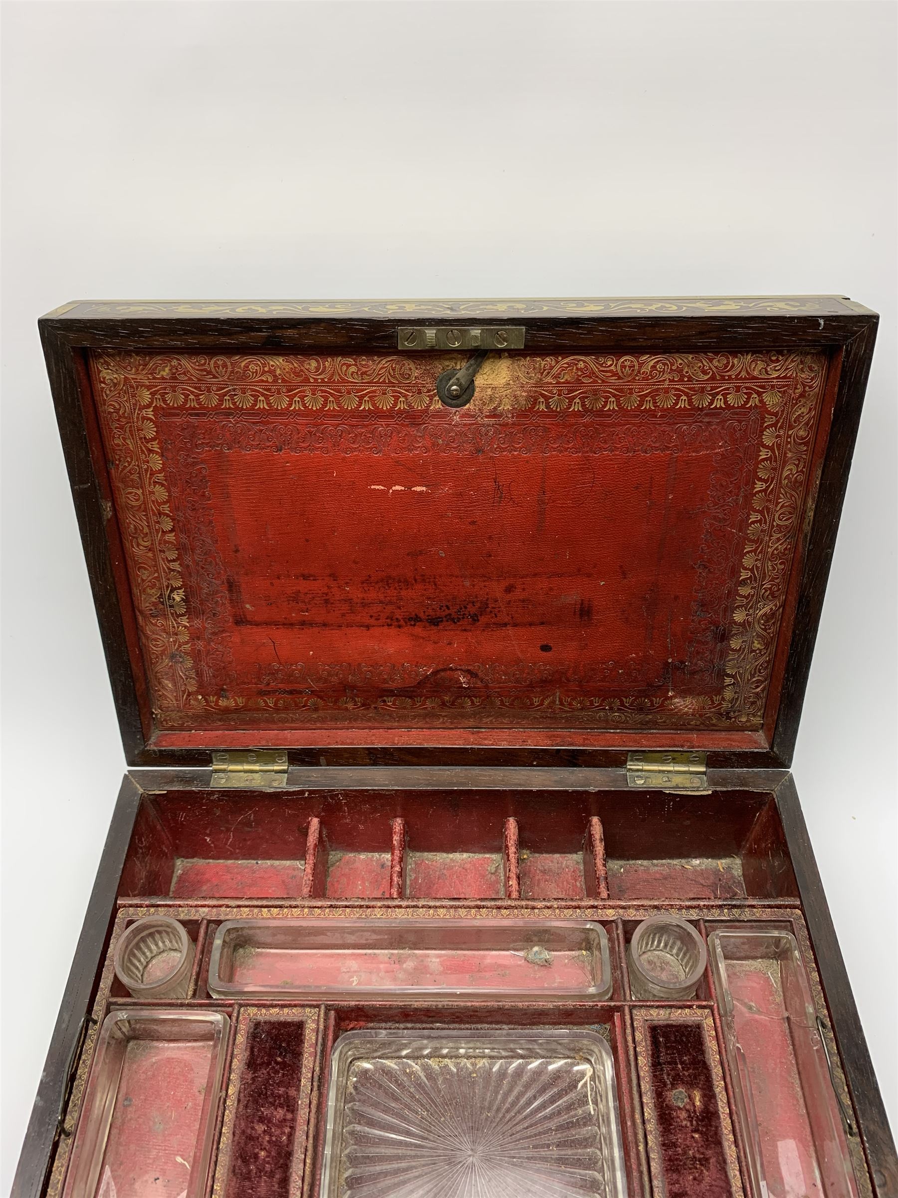 Victorian rosewood vanity box, with scrolling foliate brass inlay and twin brass inset campaign style handles, the hinged cover opening to reveal a gilt tooled interior with divisions, L33cm D22.5cm H13cm