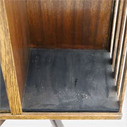 Early 20th century oak revolving bookcase, square top above four divided sections, raised on a revolving base