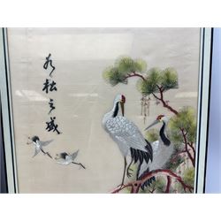 Two 20th century Chinese silk embroidered panels, the first example depicting two cranes amongst cherry blossom and pine branches, the second worked with two pheasants amongst branches with peonies, both in glazed frames, H63cm W37.5cm