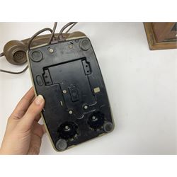 Early-mid 20th century internal telephone system, comprising exchange box with attached TMC rotary telephone and dictograph with Bakelite handset and support upon stained wood case, and 1960s black Bakelite telephone model 312L with G.P.O sticker beneath, largest H30.5cm W36.5cm D30cm