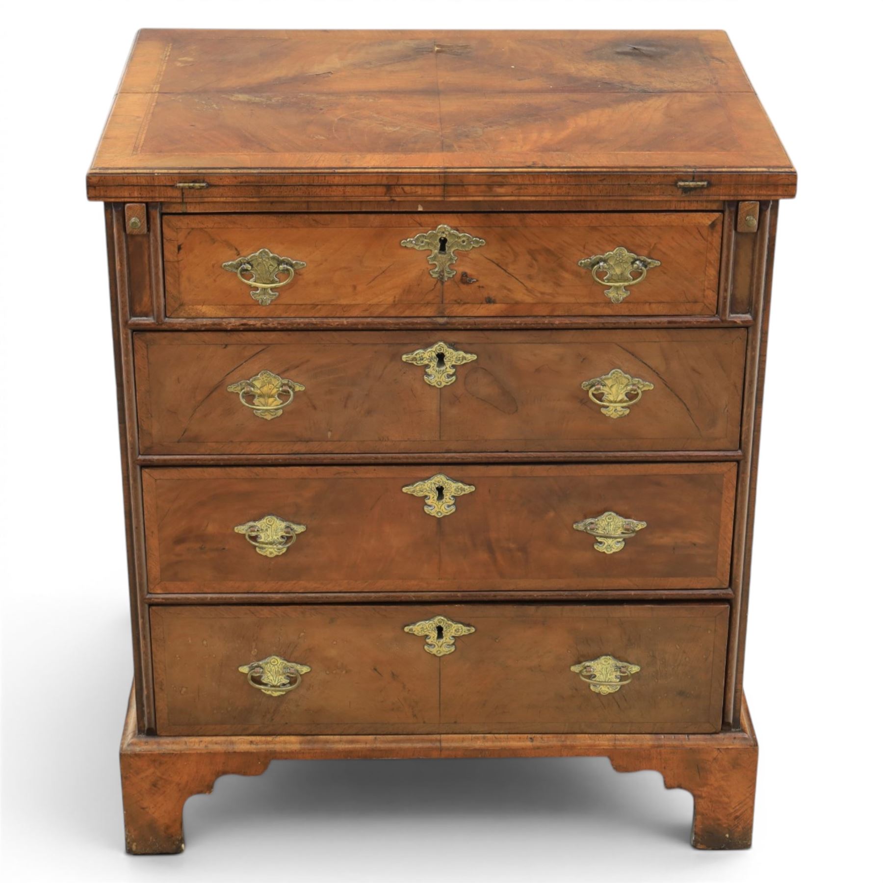 Early 20th century Georgian design figured walnut bachelor's chest, with half fold over top and lopers, over three drawers with pierced brass handles and escutcheons 
