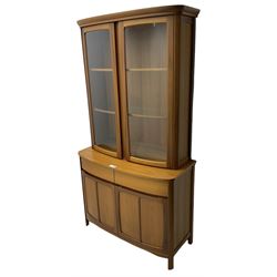 Nathan - teak wall display unit, raised display cabinet enclosed by two glazed doors, the lower section fitted with two drawers and double panelled cupboard 