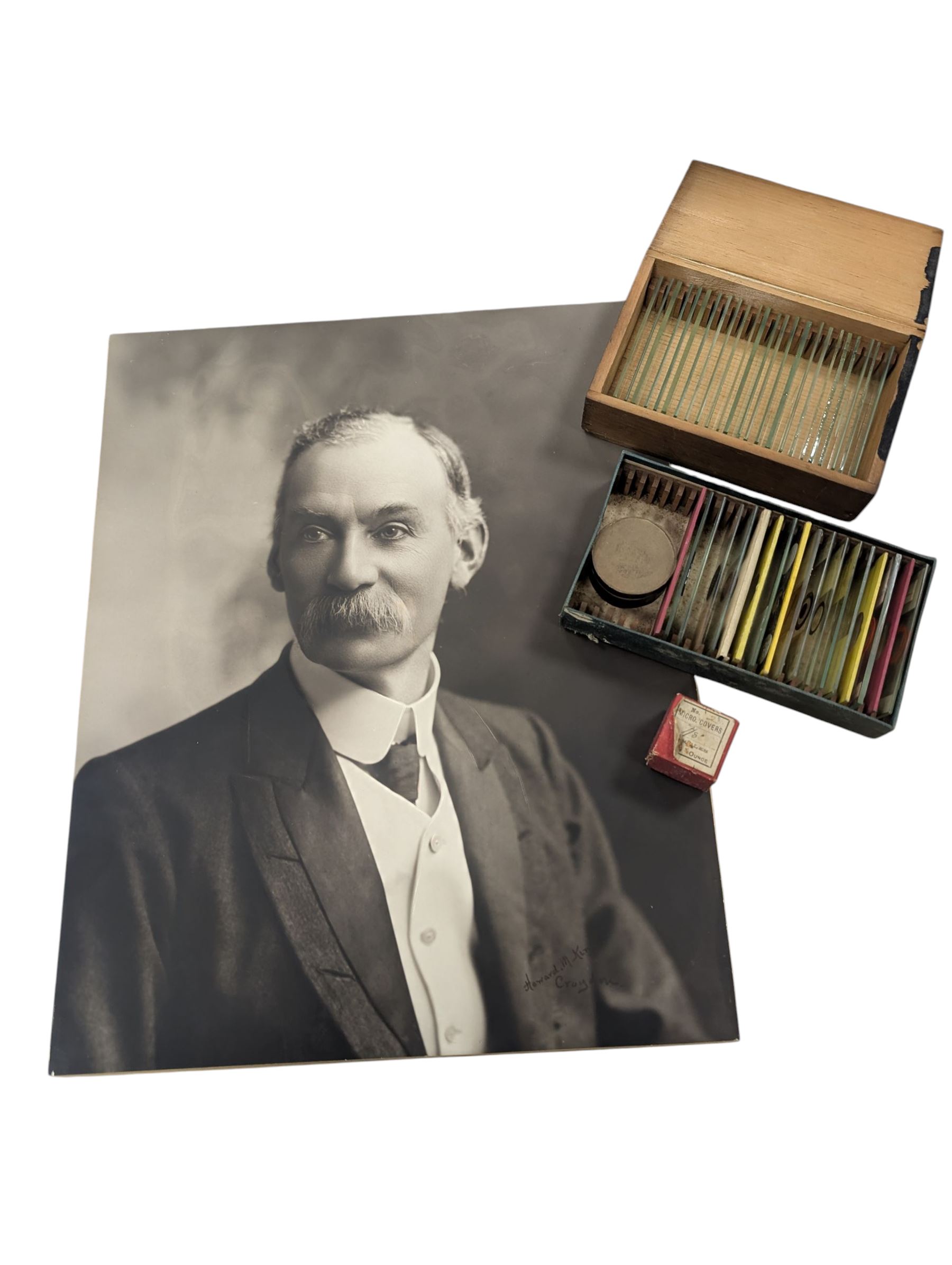 Victorian collector's specimen cabinet, containing a number of prepared microscope slides including miniature photographs, animal and human pathological, physiological and histological specimens and botanical specimens, mostly annotated in ink, the cabinet with glazed door, the drawers with bone handles and lined with green felt, owned by Dr Arthur Bristow, together with a picture of the doctor, cabinet H43cm